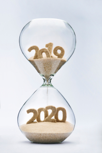 New Year 2020 concept with hourglass falling sand taking the shape of a 2020