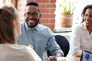 miling African American businessman at briefing, business training