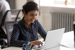 Woman using her laptop in an office