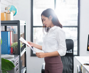 Business woman working with papers in her office