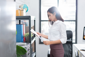 Woman reading a file in her office