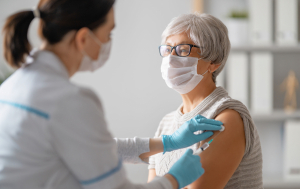 Doctor giving a woman a vaccine