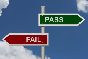 Red and Green street signs with blue sky with words Pass and Fail, Pass versus Fail Red and Green street signs with blue sky with words Pass and Fail, Pass versus Fail