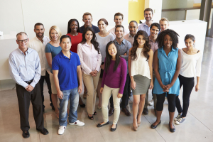 Group of employees standing in their office Group of employees standing in their office