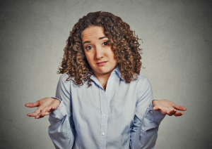 Young woman shrugging her shoulders