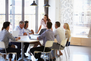 Business woman presenting to colleagues at a meeting