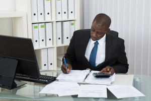 Business man using a calculator in an office