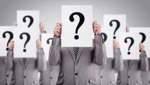Business people with question marks over faces Business people with question marks over faces