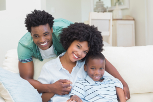 Family sitting on couch together