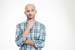 Man holding his chin looking confused