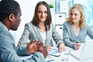 Business people working with business documents together Business people working with business documents together