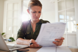 Woman sitting at a table reading a document