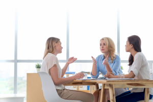Business women talking at a table