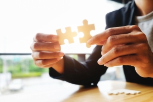 Businessman hands connecting jigsaw puzzle.