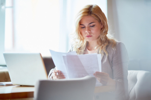 Woman looking at paperwork in her office