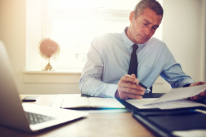 Business man working with papers at his desk