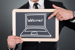 Man holding a chalkboard with the word webinar
